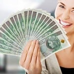 Woman holding a clip of polish money in hand